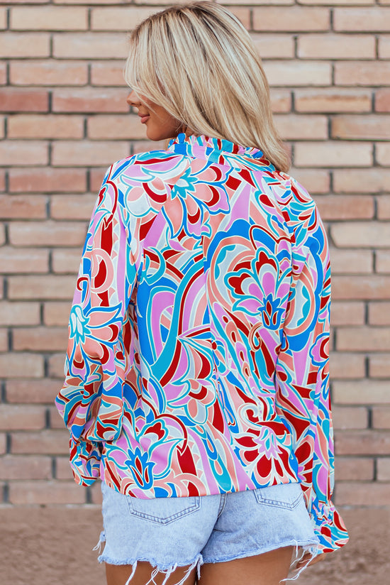 Pink blouse with abstract print and ruffled collar and ruffle sleeves