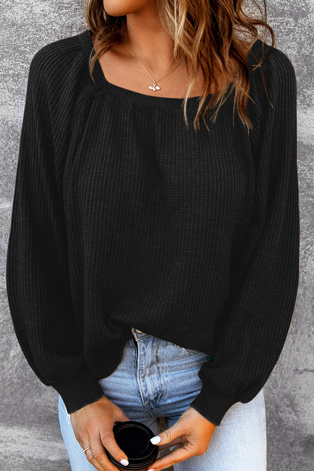 Black waffle knit top with puff sleeves and scoop neck