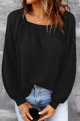 Black waffle knit top with puff sleeves and scoop neck