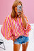 Orange striped blouse, balloon sleeves, notched v collar, buttoned on the front