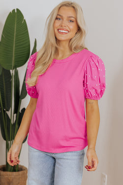 Bright ribbed pink with puffy sleeves and pearls *