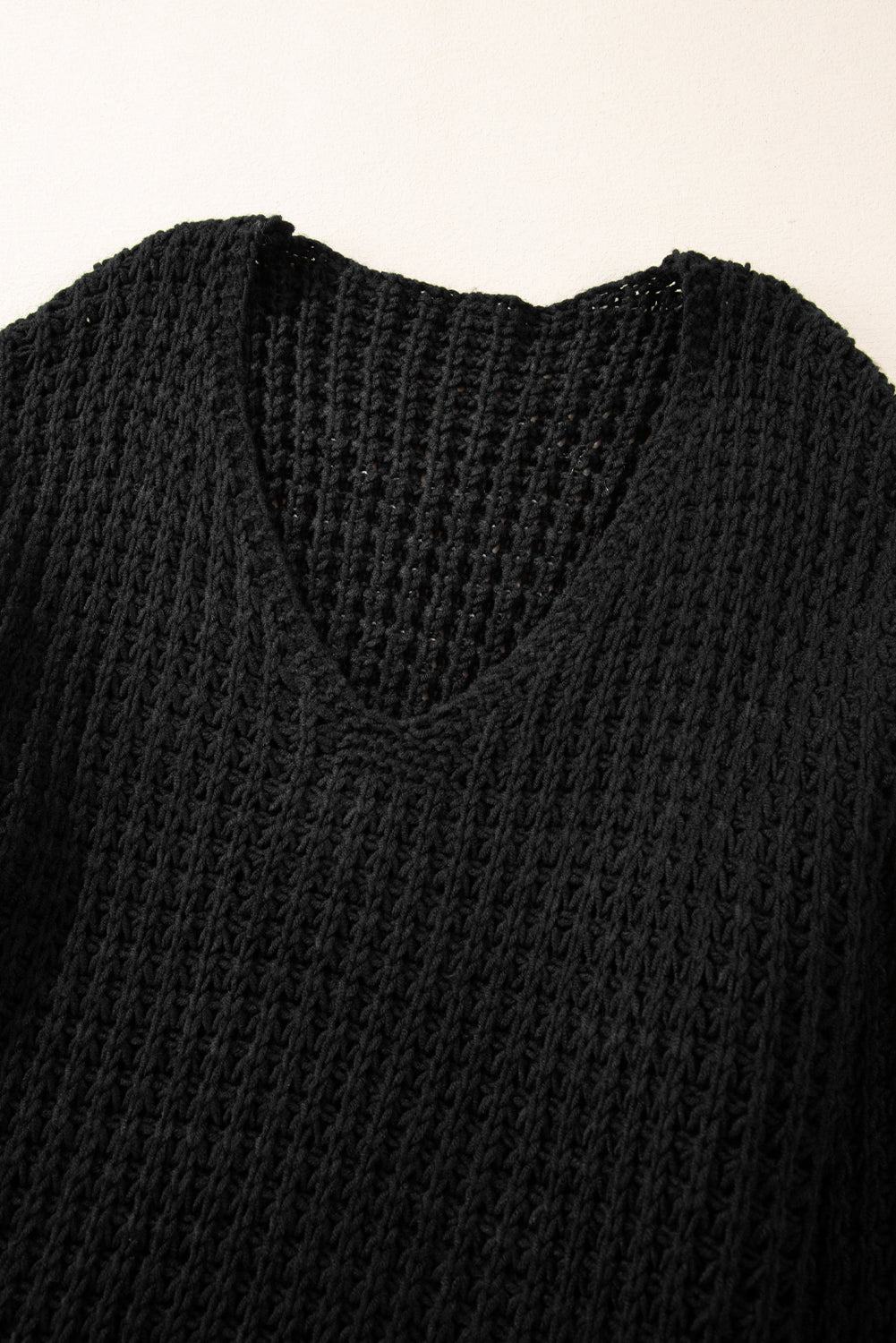 Black V-neck sweater with openwork crochet