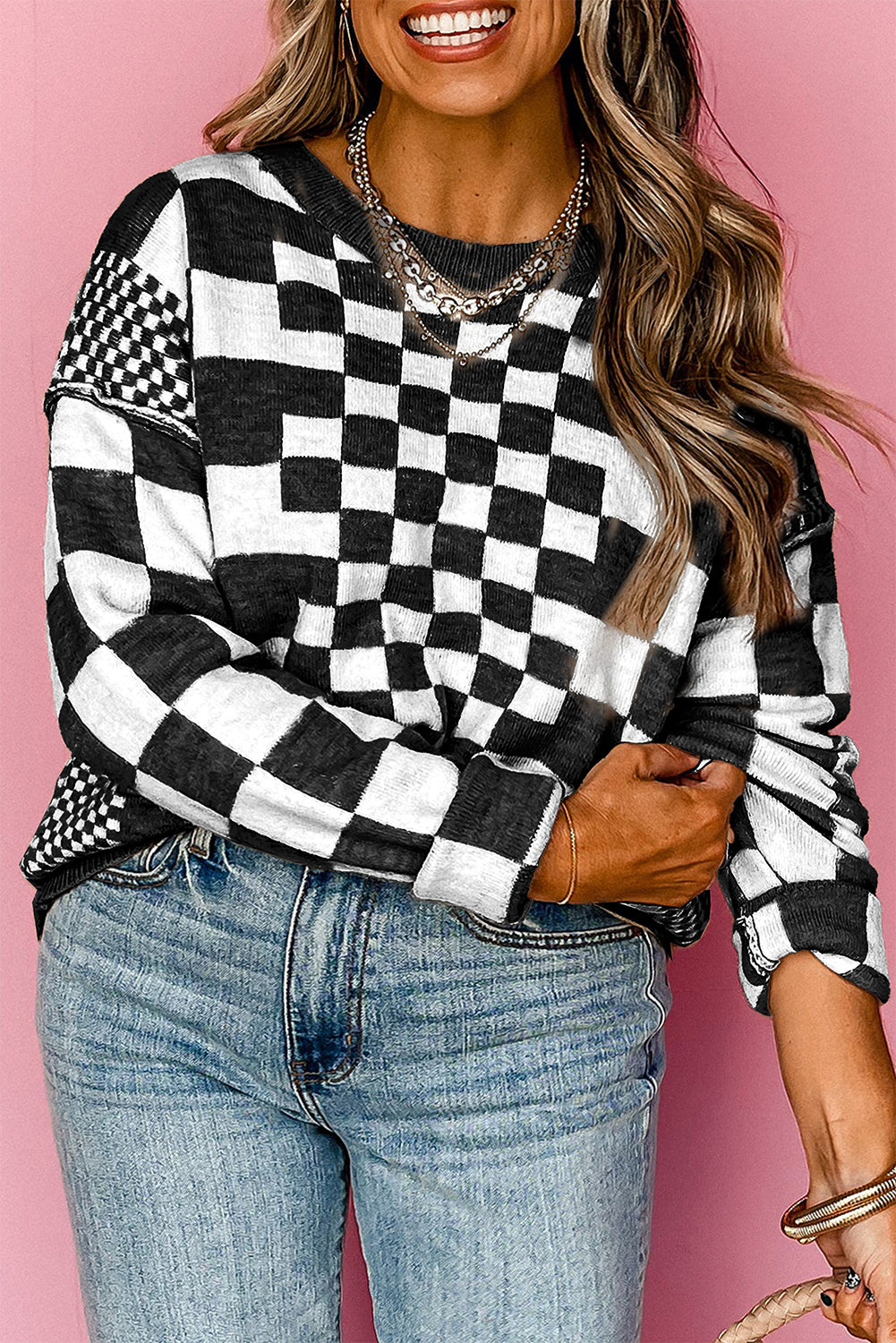 Black crew neck sweater with dropped shoulders and plaid print