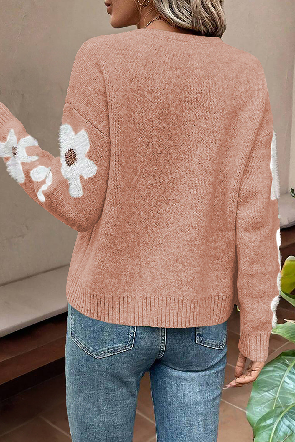 Light pink sweater with floral sleeves and dropped shoulders