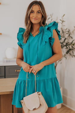 Green mini dress with ruffled sleeves and pockets