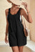 Black textured romper with adjustable straps and pockets