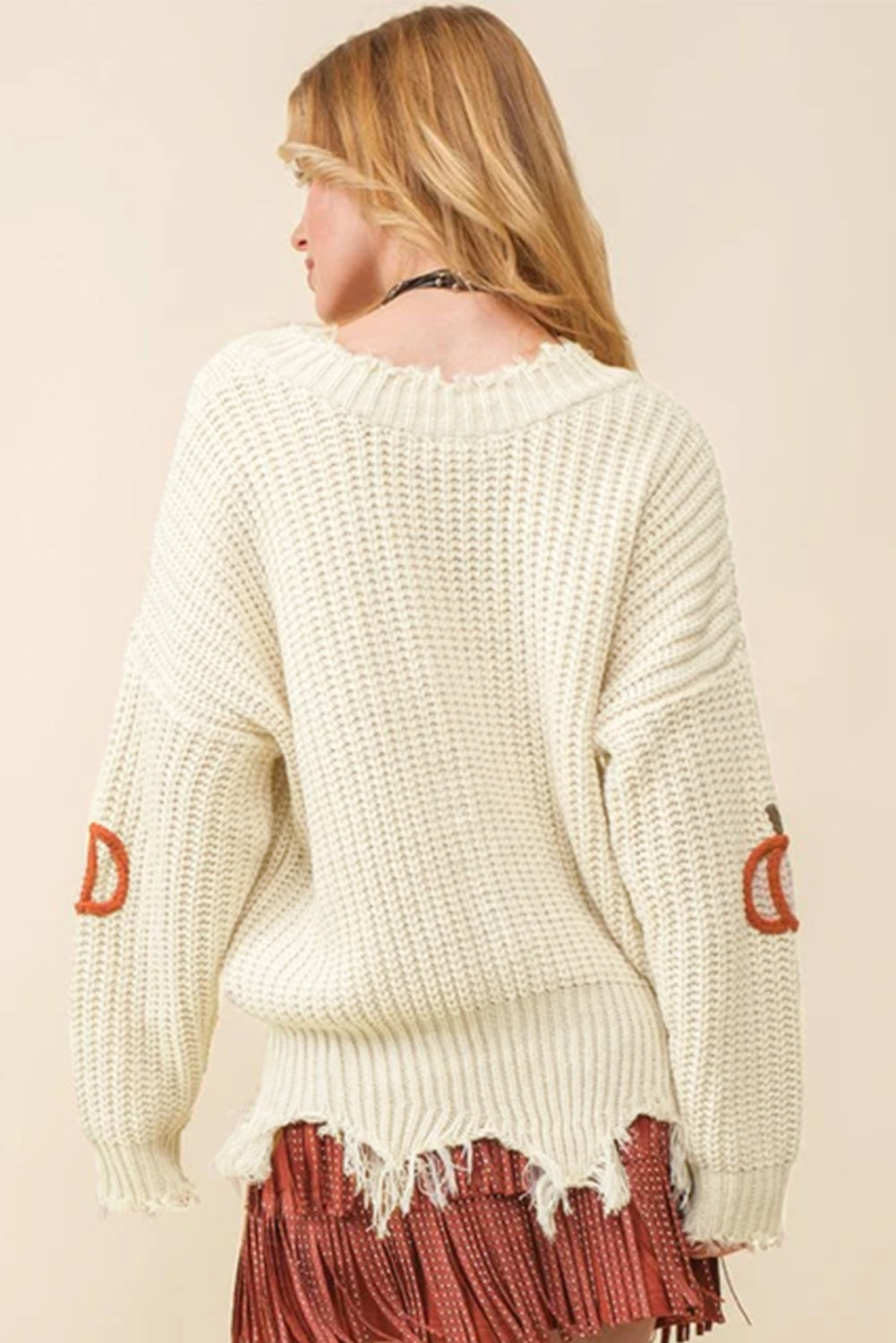 Beige cable knit loose sweater with raw hem and V-neck