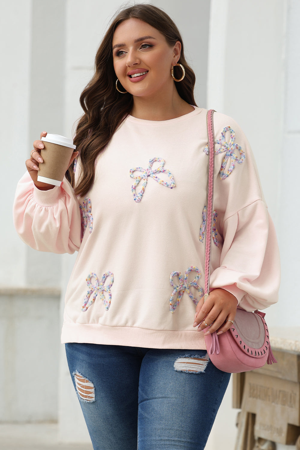 Oversized sweatshirt with lantern sleeves and parchment embroidered bow