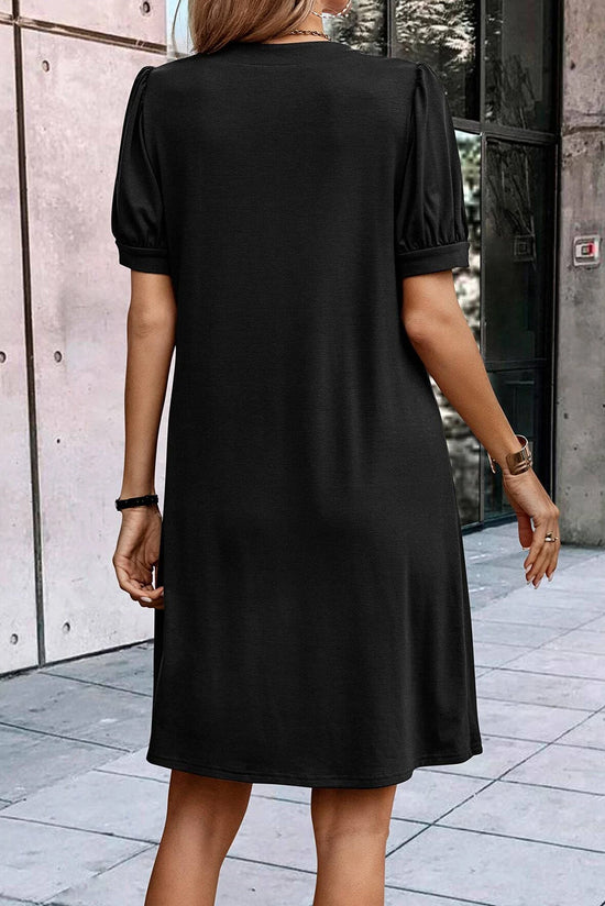 Vestido negro de camiseta derecha con cuello con muescas y mangas hinchadas plisadas