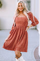 Brown suede dress with square neck and puffed sleeves