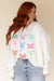 White loose sweatshirt with bow tie pattern and dropped shoulders