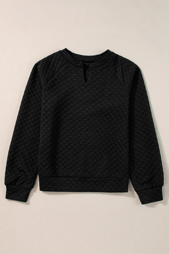 Black quilted top with long sleeves and split collar