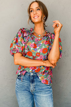 Red blouse with puffy sleeves and ruffles with split collar and floral tie