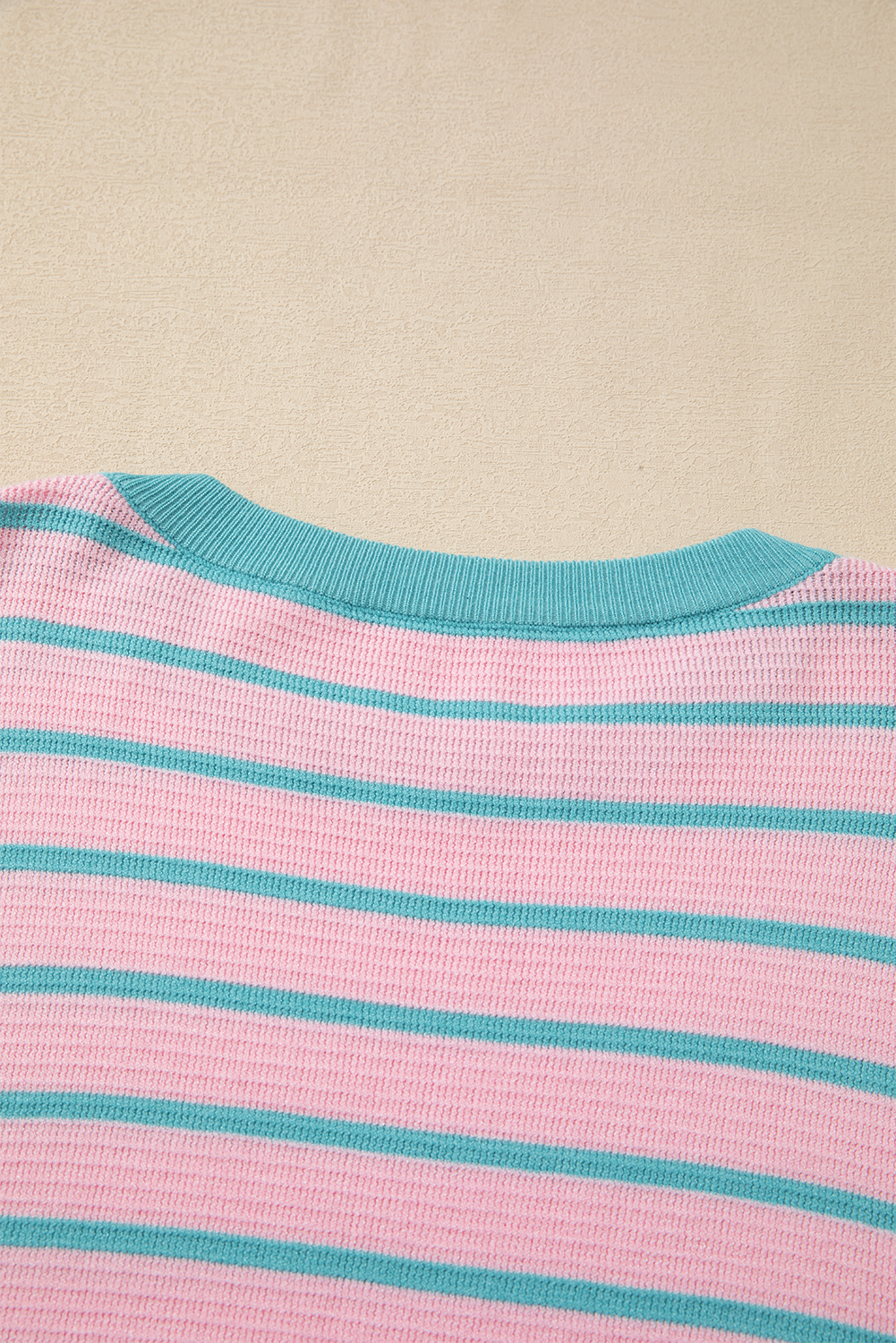 Loose sweater with pink stripes and round neck, dropped shoulders