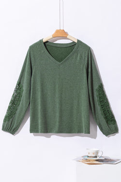 Green top with raglan sleeves and crochet lace patch