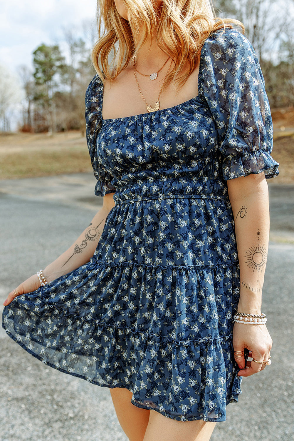 Short dress with ruffles and floral smocking in voile blue