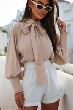 Khaki blouse with ruffles and flared sleeves with an upright and knotted collar