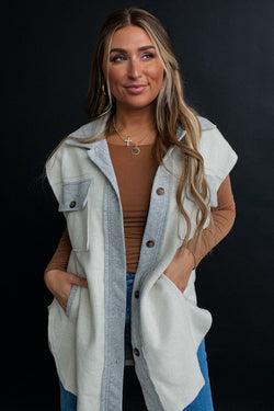 Light grey jacket with flap pockets and contrasting buttons on the front