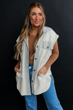 Light grey jacket with flap pockets and contrasting buttons on the front