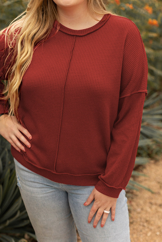 Plus size waffle knit top with exposed seams and gold flame