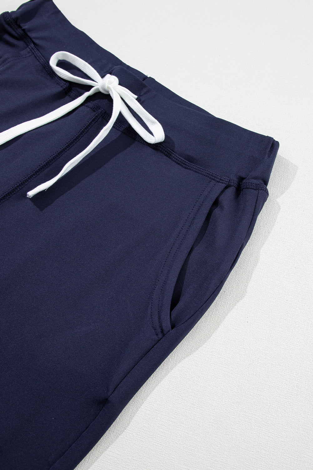 Navy blue jogging pants with pockets and drawstring waist