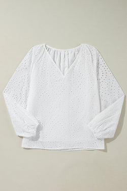 White blouse with puffy sleeves and V -collar embroidered with eyelets