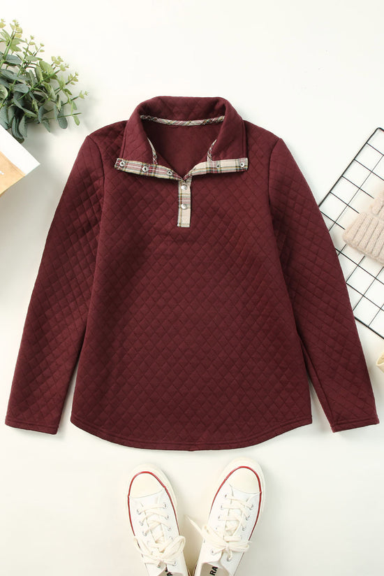 Bright red sweatshirt with geometric texture and plaid trim