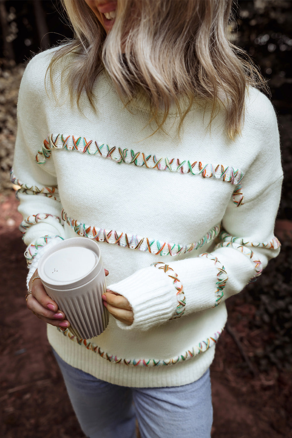 Colorful white sweater with dropped shoulders and crossed stitches