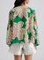 Large folded shirt with puffy sleeves and green floral print button