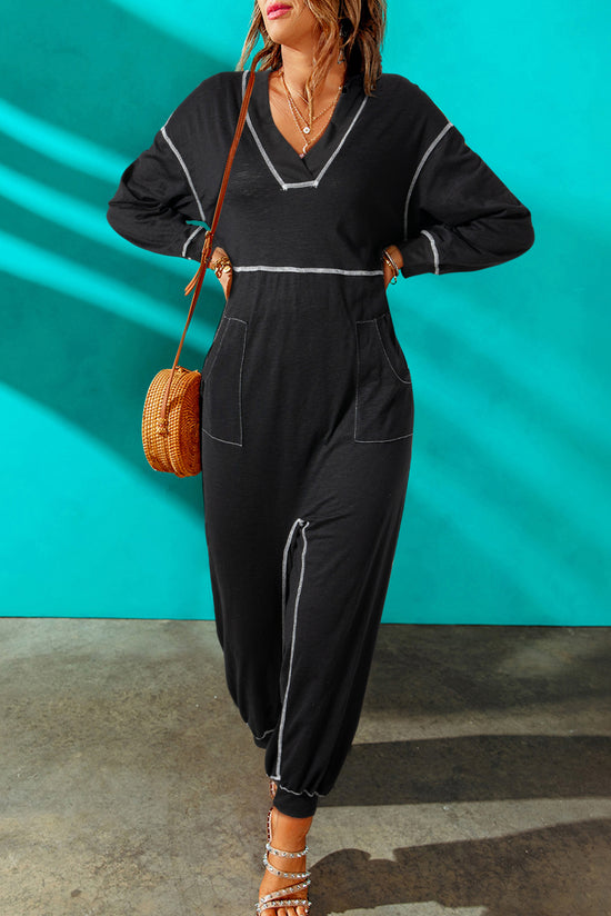 Black baggy jumpsuit with v-neck and flat seam details