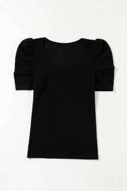 Black top with gathered puffy sleeves in embossed knitting