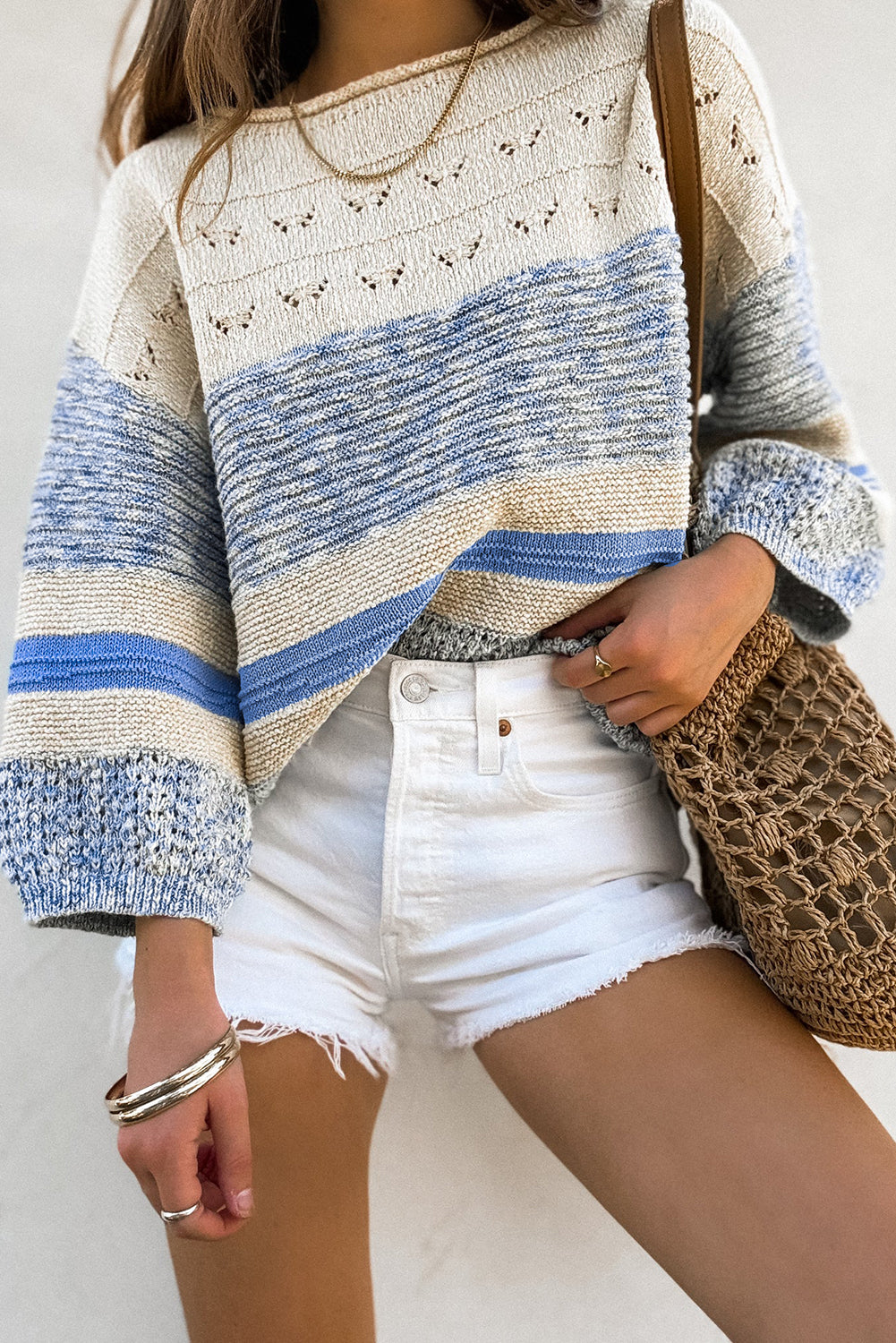 Light blue sweater with puffed sleeves and open stitch