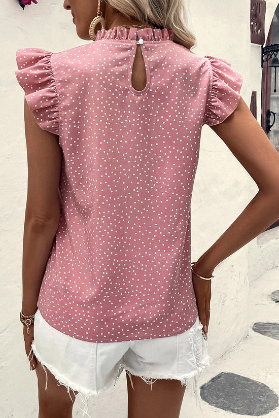 Blouse rose à pois et volants à manches flottantes et col à volants