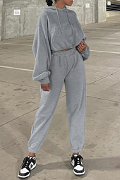 Set of plain gray sports clothes with hooded sweatshirt and jogging pants with falling shoulders