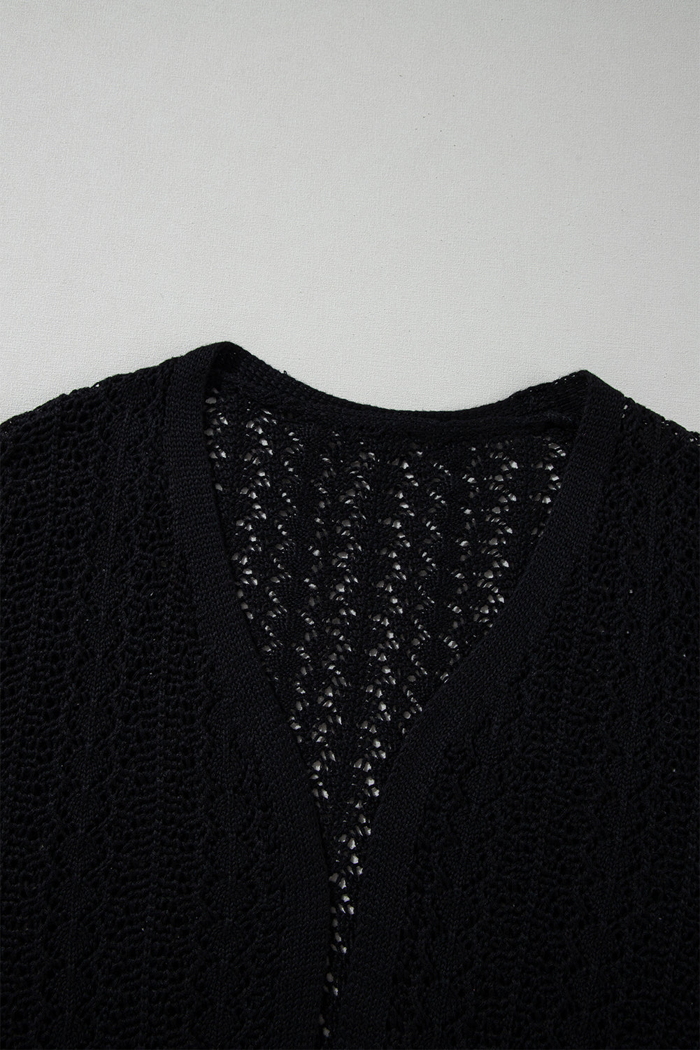 Black open front cardigan in openwork knit with dropped shoulders