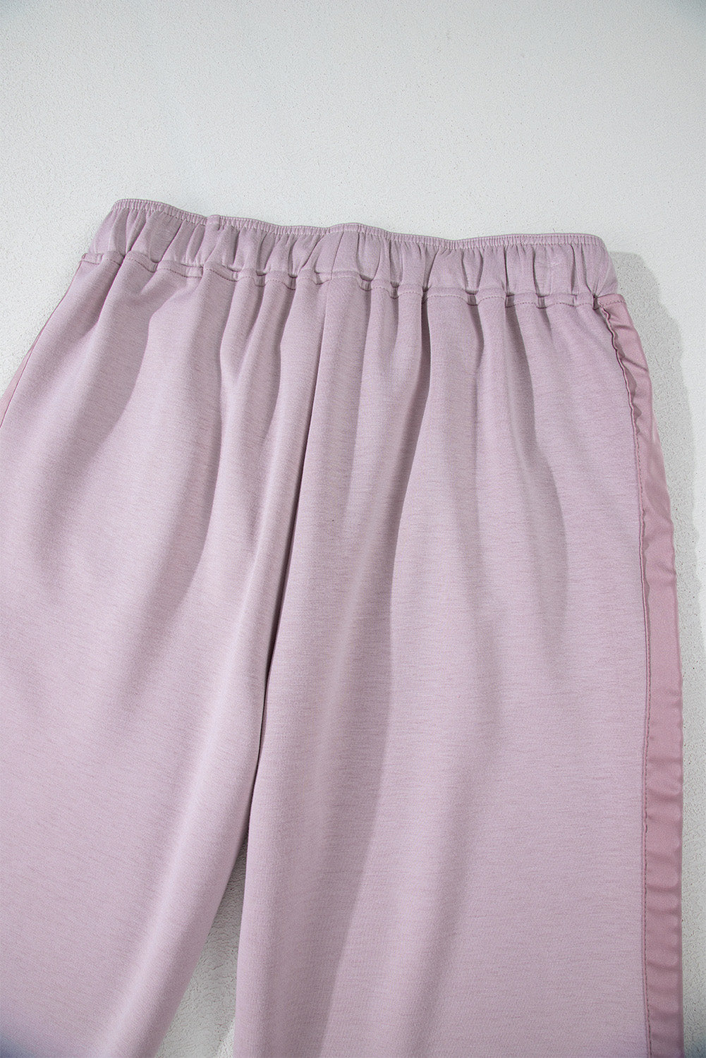 High waist pants with tightening cord and orchid petals, satin striped patch, right leg