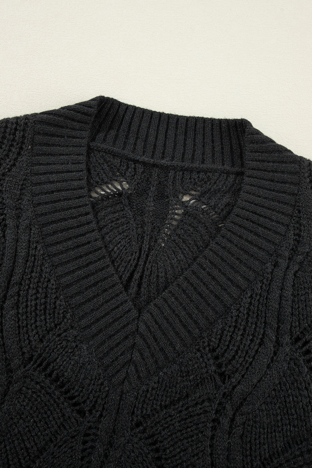 Black openwork knit sweater with V-neck and dropped shoulders