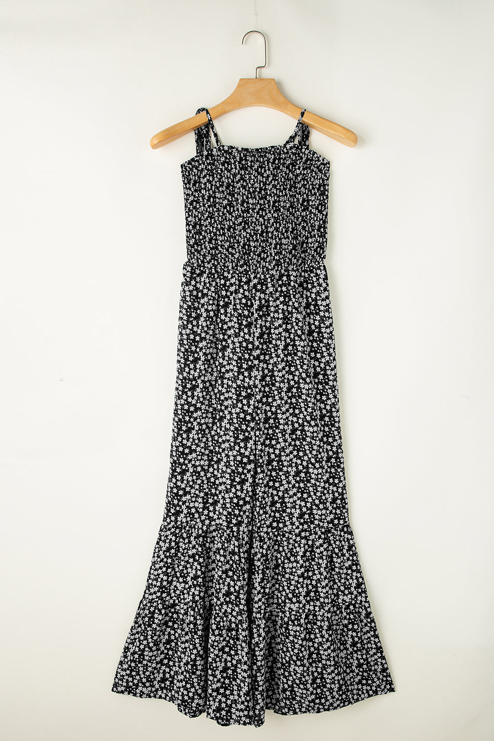 Black floral jumpsuit with thin straps and smocked bodice