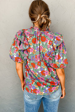 Red blouse with puffy sleeves and ruffles with split collar and floral tie