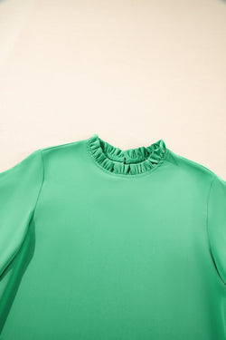 Green blouse with ruffles, round neck *