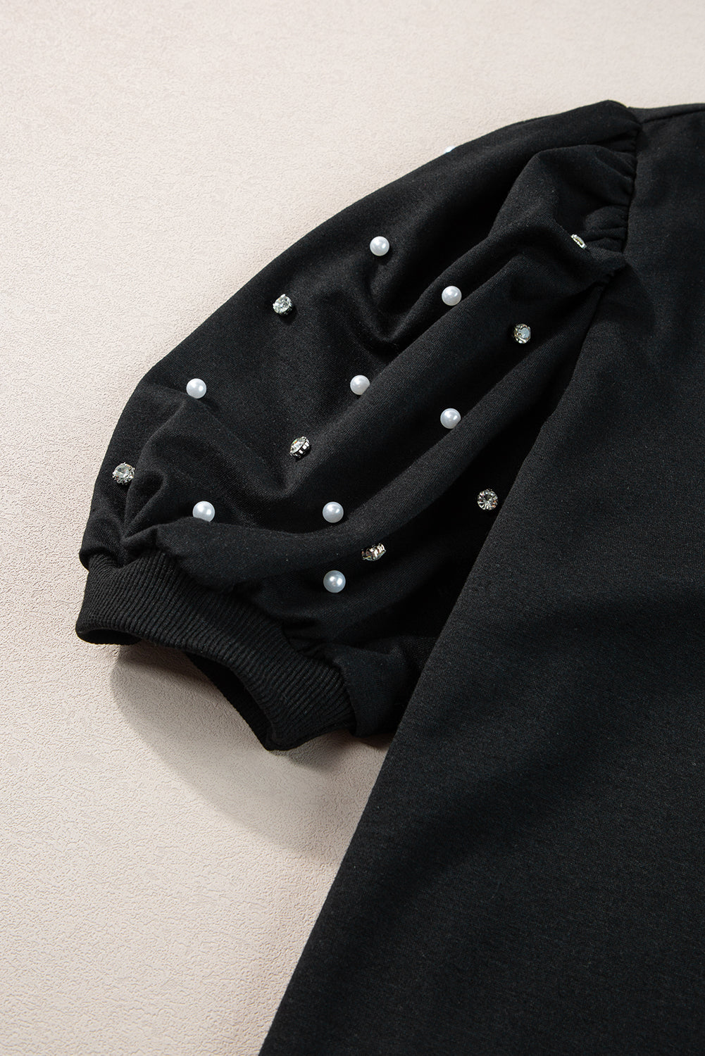 Black top with mid-long puffing sleeves with pearls and rhinestones