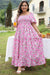 Smocked pink dress with puffy sleeves and large floral print