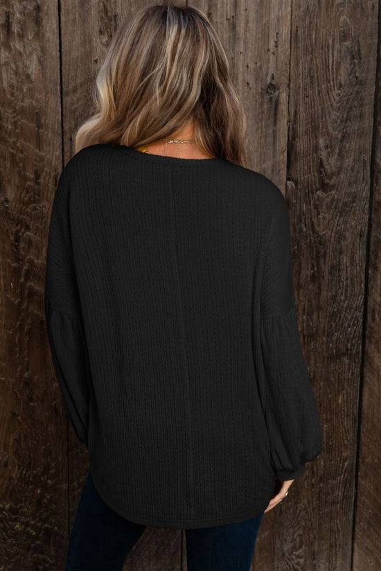 Black long puff sleeve top in faux knit jacquard