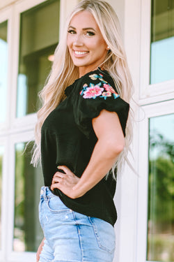 Black high with V -neck and puffy sleeves embroidered with flowers