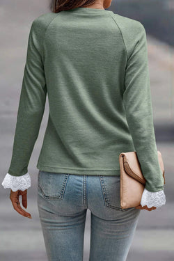 Grass green top with raglan sleeves and contrasting lace cuffs with contrasting stitching