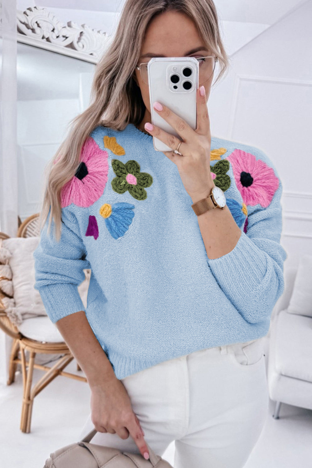 Light blue knitted sweater with ribbed edges and floral pattern