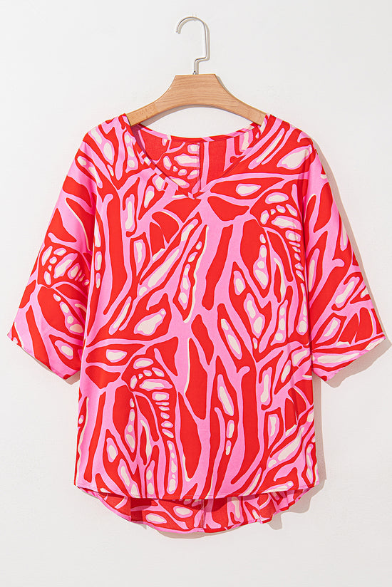 Oversize red blouse with abstract print, V-neck, bat handles