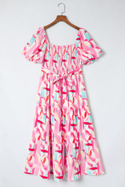 Smocked pink dress with ruffles and brush kick print