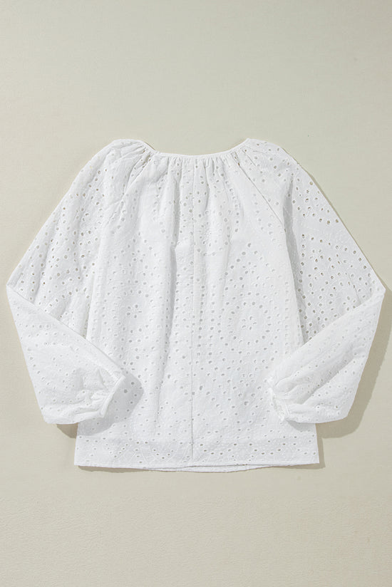 White blouse with puffy sleeves and V -collar embroidered with eyelets