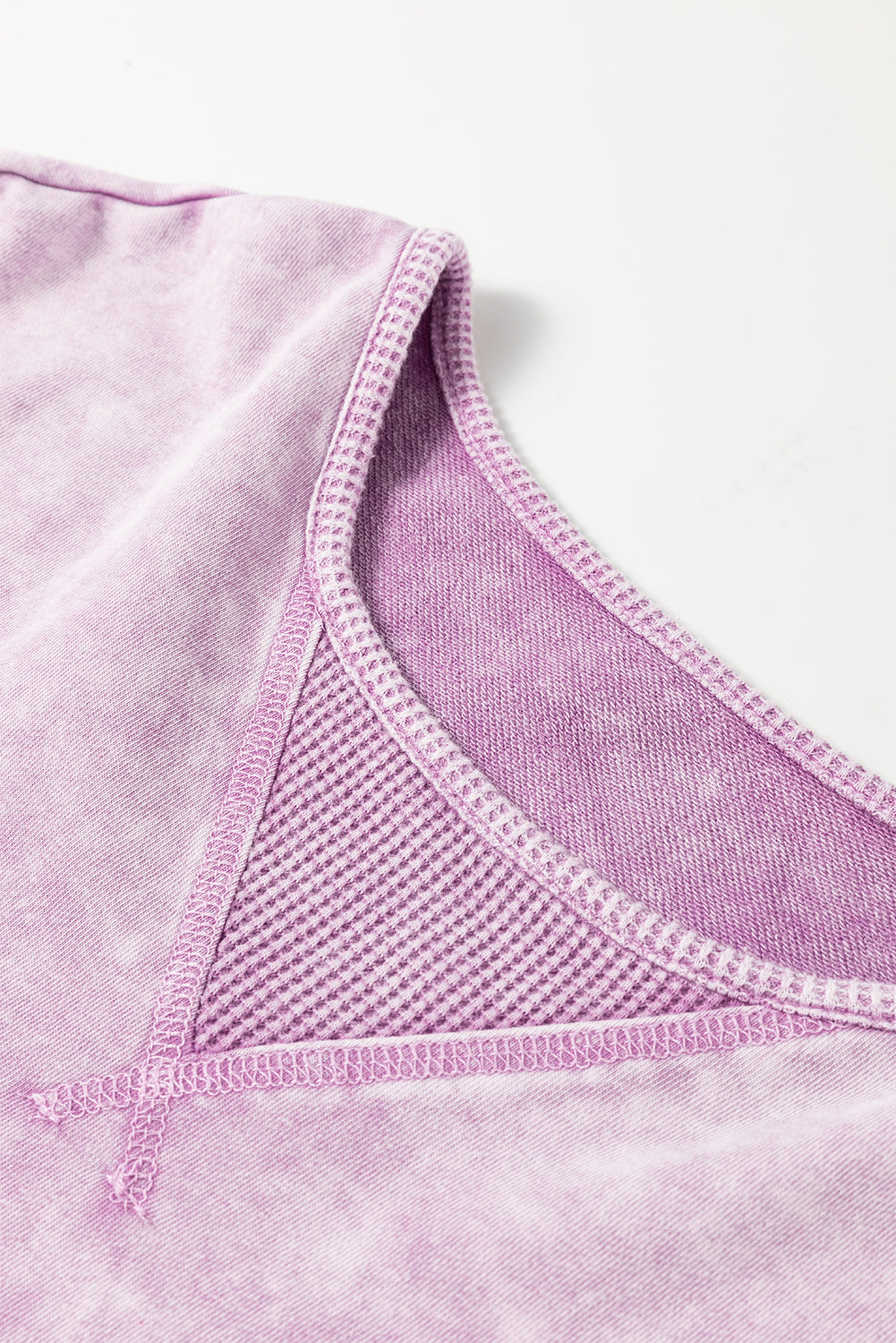 Surprised t-shirt with drooping shoulders and visible seams with mineral washed out and orchid petals